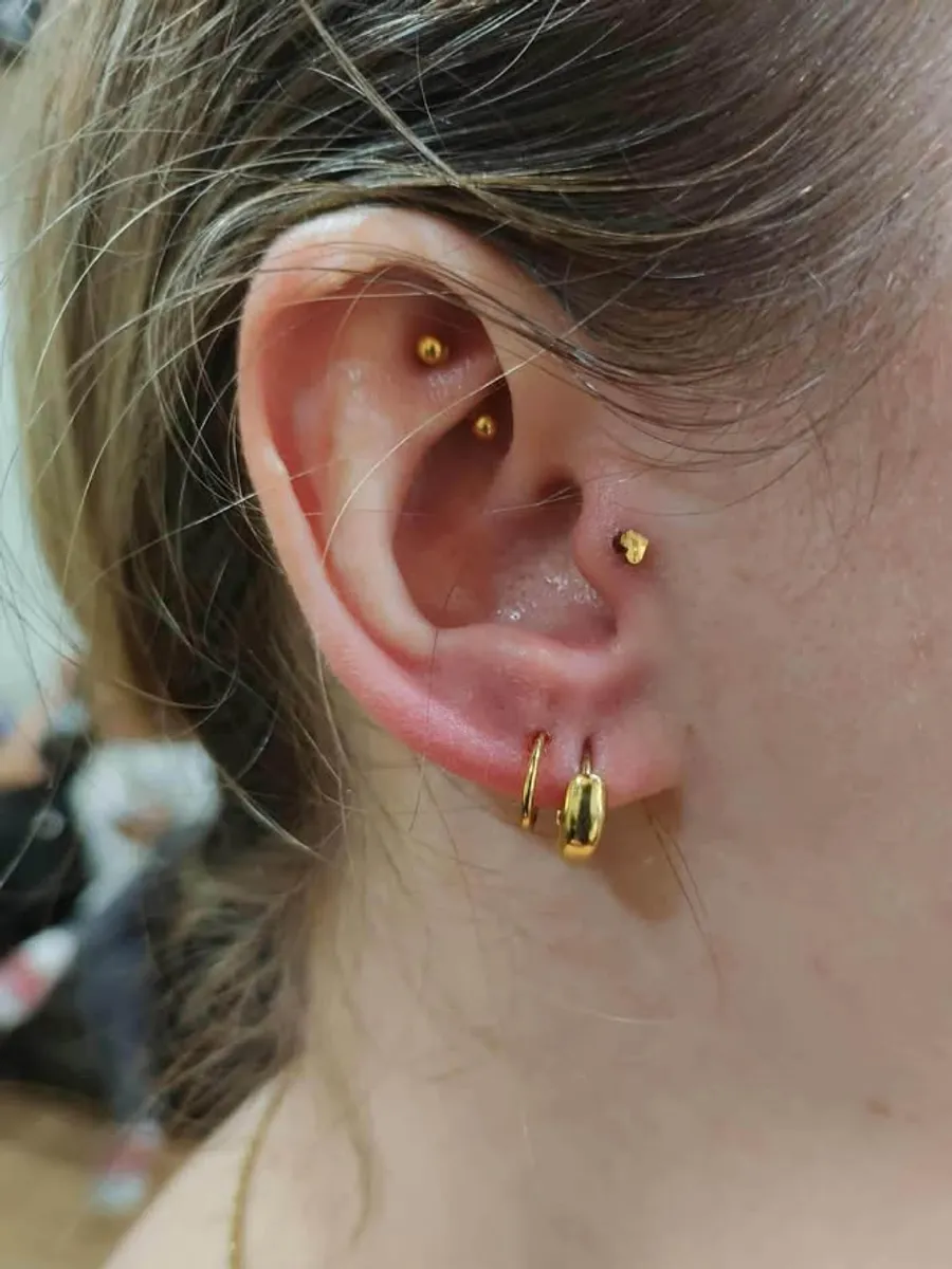 Helix and lobe ear piercing by RUN INK Tattoo Bangkok