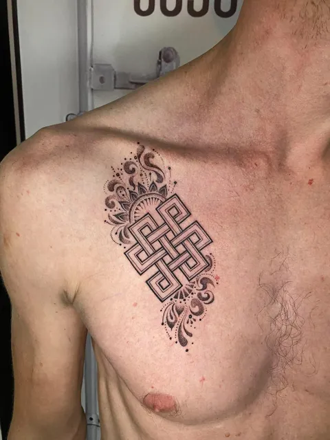 Black and Grey endless knot mandala chest tattoo by RUN INK Tattoo Bangkok
