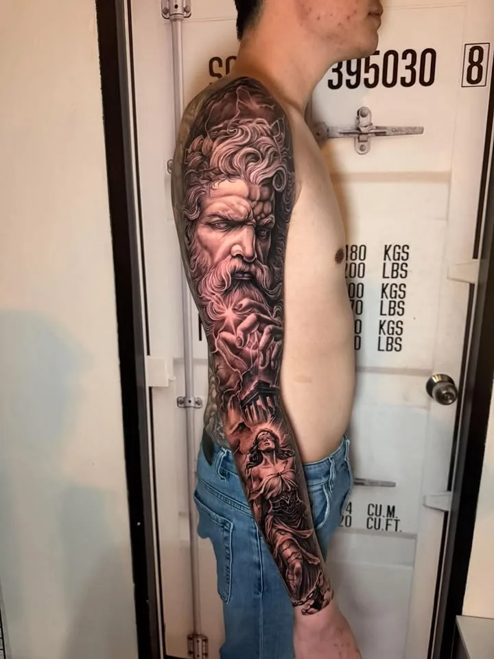 Black & Grey Zeus full sleeve tattoo by RUN INK Tattoo Bangkok